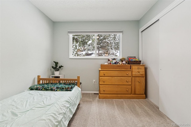 bedroom featuring a closet, carpet floors, and a textured ceiling