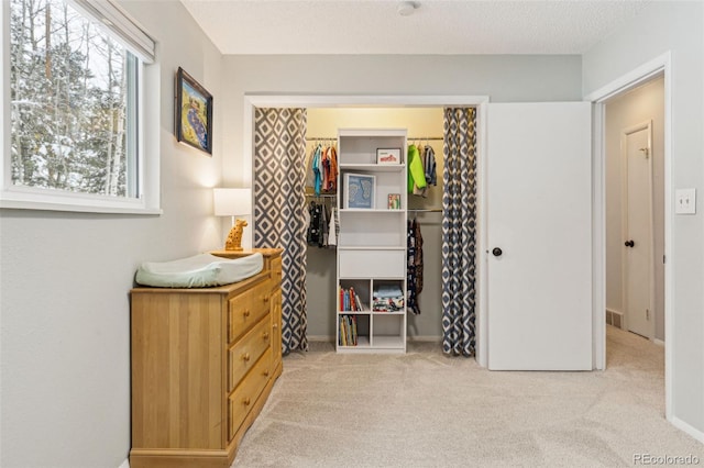 carpeted bedroom featuring visible vents, a closet, and a textured ceiling