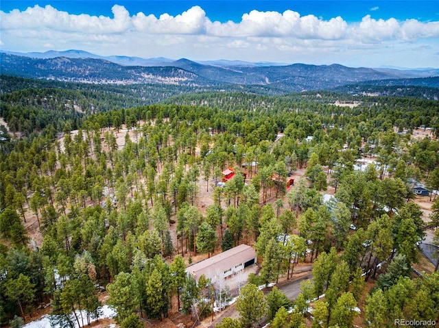 bird's eye view featuring a mountain view and a wooded view