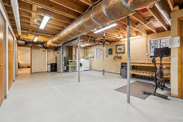 unfinished basement with water heater and washer and clothes dryer