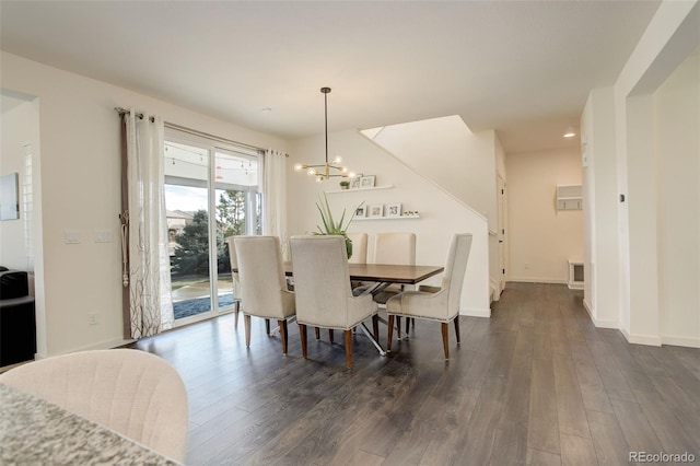 dining space with a notable chandelier and dark hardwood / wood-style floors