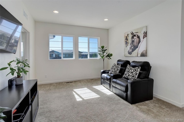 sitting room featuring light carpet