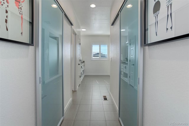 hall with tile patterned flooring