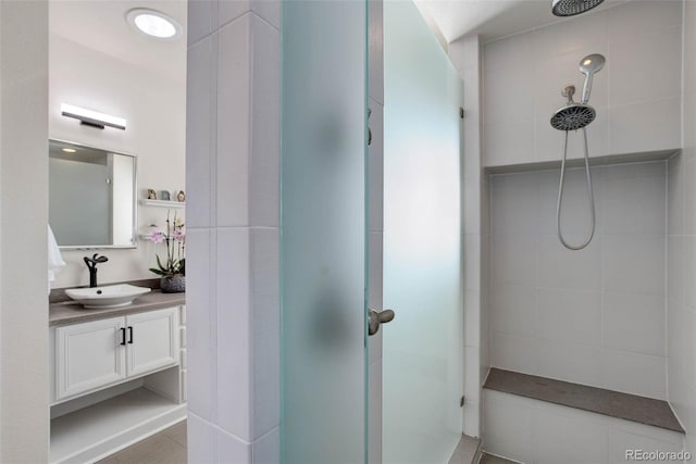 bathroom featuring vanity and a tile shower