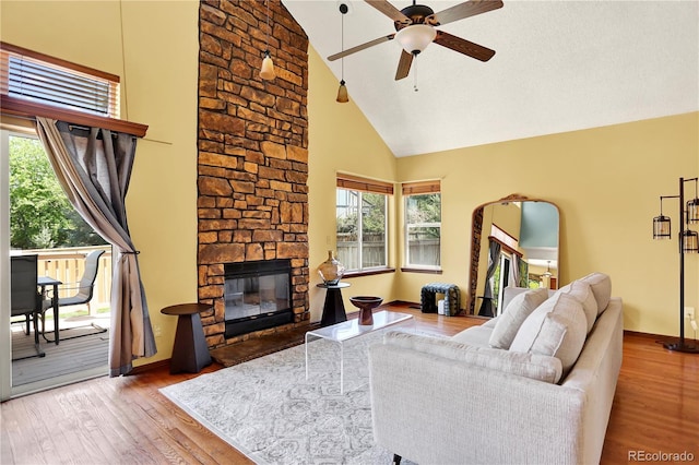 9682 Hemlock Ct, Highlands Ranch, CO 80130 - living room with high vaulted ceiling, a ceiling fan, wood finished floors, and a fireplace
