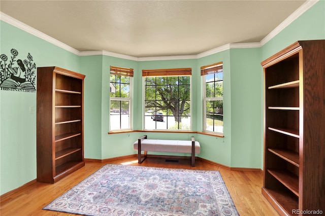 9682 Hemlock Ct, Highlands Ranch, CO 80130 - sitting room with wood finished floors and crown molding