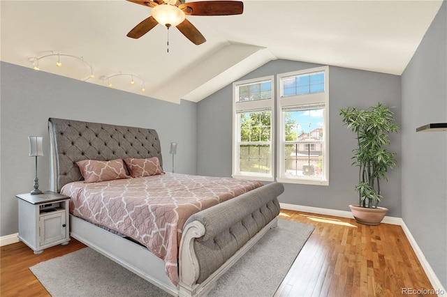 9682 Hemlock Ct, Highlands Ranch, CO 80130 - bedroom featuring wood finished floors, vaulted ceiling, and ceiling fan