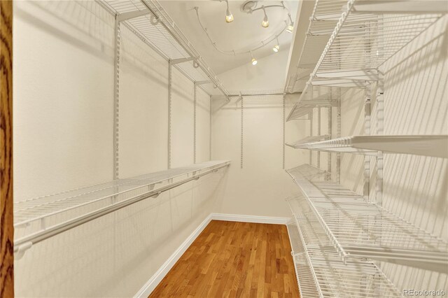 9682 Hemlock Ct, Highlands Ranch, CO 80130 - walk in closet featuring wood finished floors