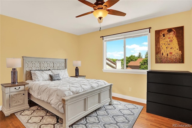 9682 Hemlock Ct, Highlands Ranch, CO 80130 - bedroom with light wood finished floors and ceiling fan