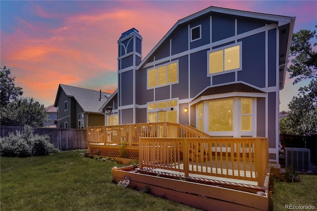 9682 Hemlock Ct, Highlands Ranch, CO 80130 - back of property with a wooden deck, a chimney, and stucco siding