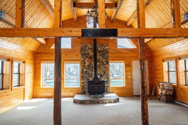 unfurnished living room with wood ceiling, light carpet, and beam ceiling