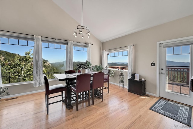 31324 Kings Vly, Conifer, CO 80433 - dining space featuring lofted ceiling, a chandelier, light wood-style flooring, and baseboards