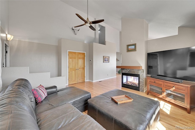 31324 Kings Vly, Conifer, CO 80433 - living room with high vaulted ceiling, ceiling fan, wood finished floors, baseboards, and a multi sided fireplace