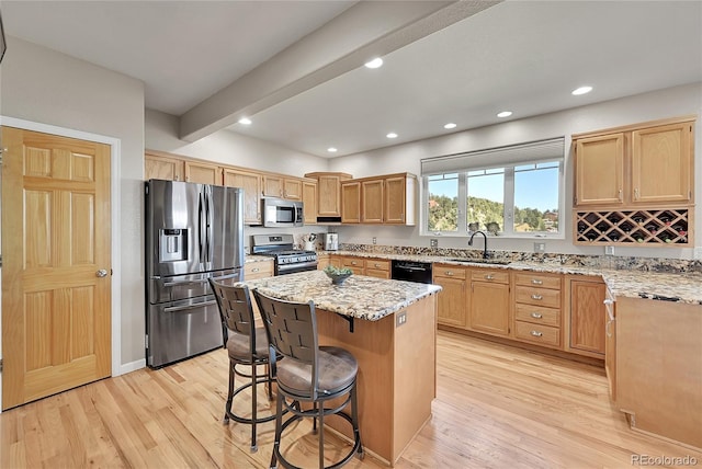 31324 Kings Vly, Conifer, CO 80433 - kitchen with stainless steel appliances, light stone countertops, light wood-style flooring, a breakfast bar, and recessed lighting
