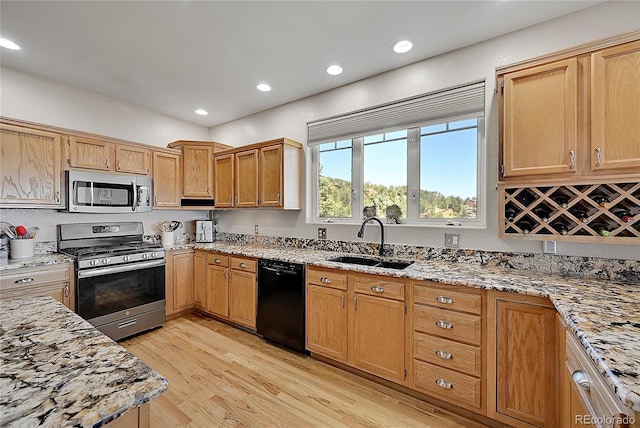 31324 Kings Vly, Conifer, CO 80433 - kitchen featuring appliances with stainless steel finishes, a sink, light wood-style floors, light stone counters, and recessed lighting