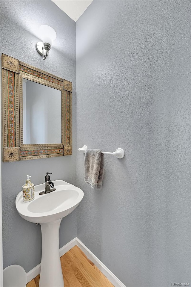 31324 Kings Vly, Conifer, CO 80433 - bathroom with wood finished floors and baseboards
