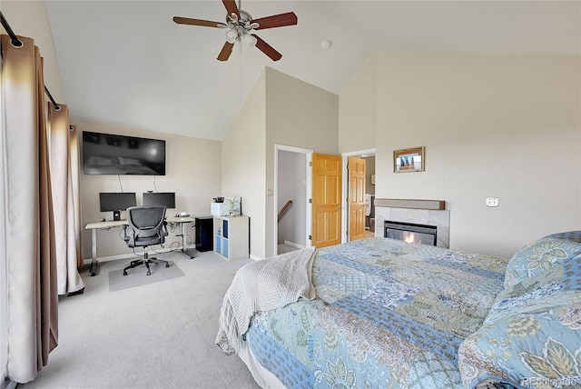 31324 Kings Vly, Conifer, CO 80433 - carpeted bedroom with high vaulted ceiling, a desk, baseboards, a tile fireplace, and ceiling fan