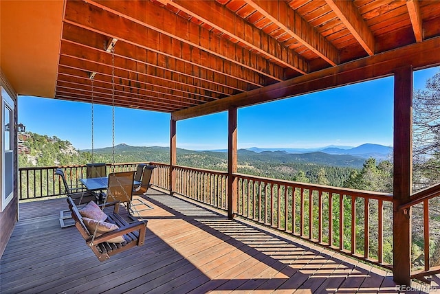 31324 Kings Vly, Conifer, CO 80433 - wooden terrace featuring outdoor dining area and a mountain view