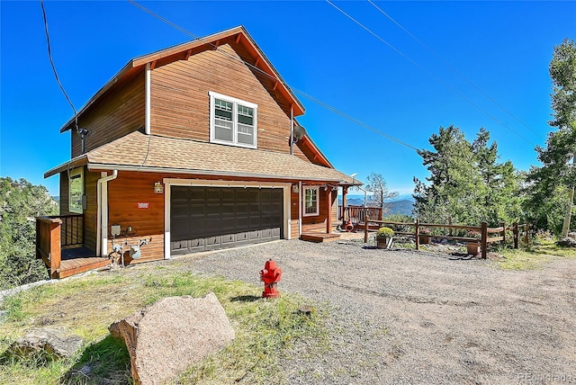 31324 Kings Vly, Conifer, CO 80433 - view of property exterior with driveway, an attached garage, and a shingled roof