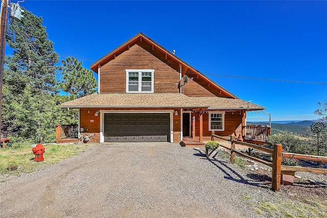 31324 Kings Vly, Conifer, CO 80433 - chalet / cabin with an attached garage, driveway, covered porch, roof with shingles, and a mountain view
