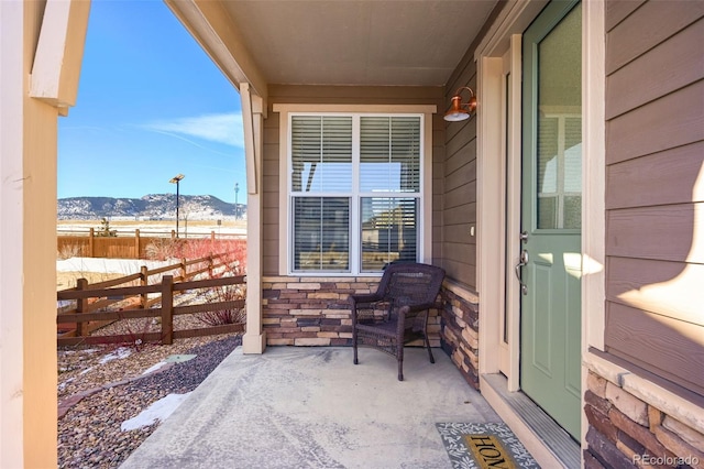 snow covered patio featuring a mountain view