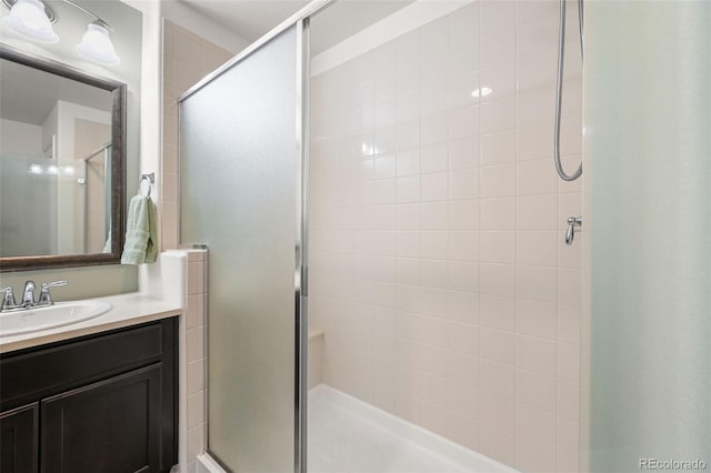 bathroom with vanity and a shower with door