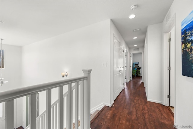 corridor with dark hardwood / wood-style flooring