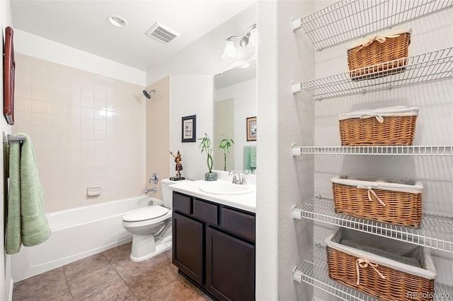 full bathroom featuring tiled shower / bath, toilet, tile patterned floors, and vanity