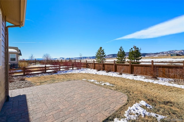 snow covered patio featuring a mountain view