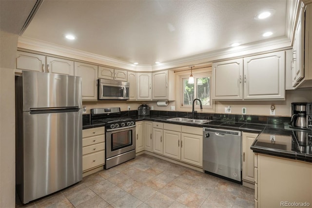 kitchen with crown molding, sink, cream cabinetry, and appliances with stainless steel finishes