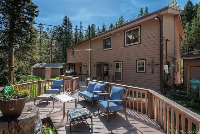 deck with outdoor lounge area and a storage unit