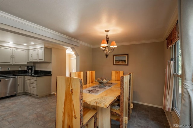 dining area featuring crown molding and a chandelier