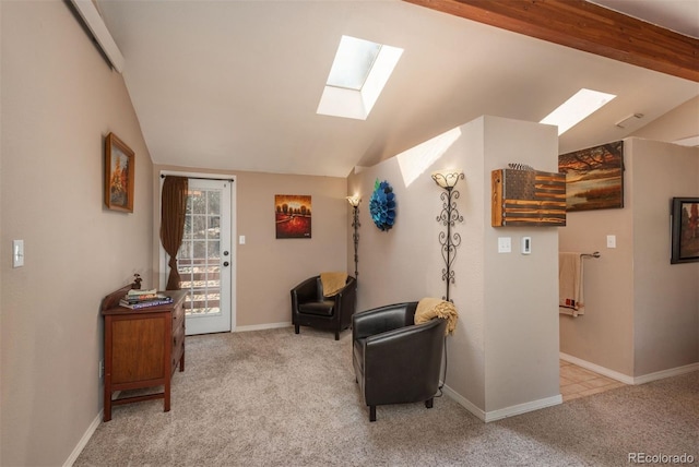 sitting room with lofted ceiling with beams and light colored carpet