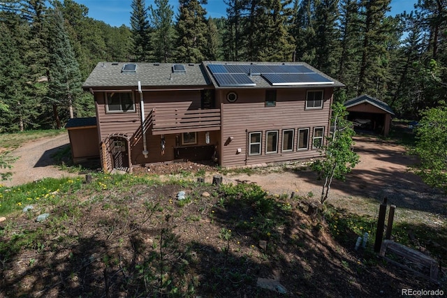 rear view of house with solar panels