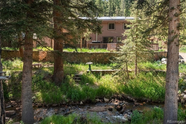 view of yard featuring a deck with water view