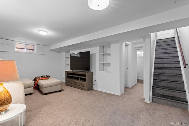 living room featuring built in shelves and light carpet