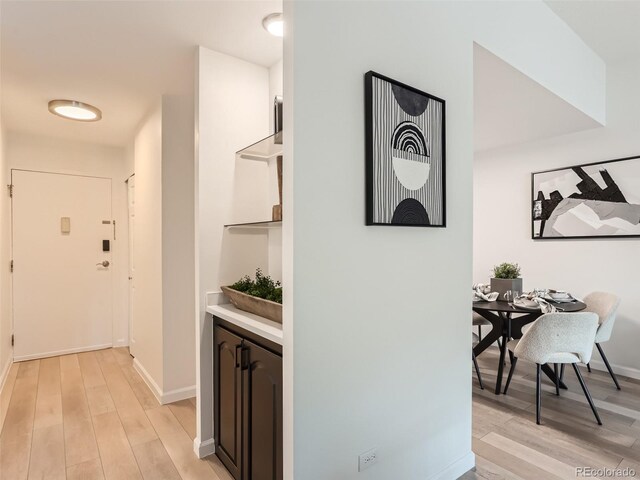 hallway with light hardwood / wood-style flooring