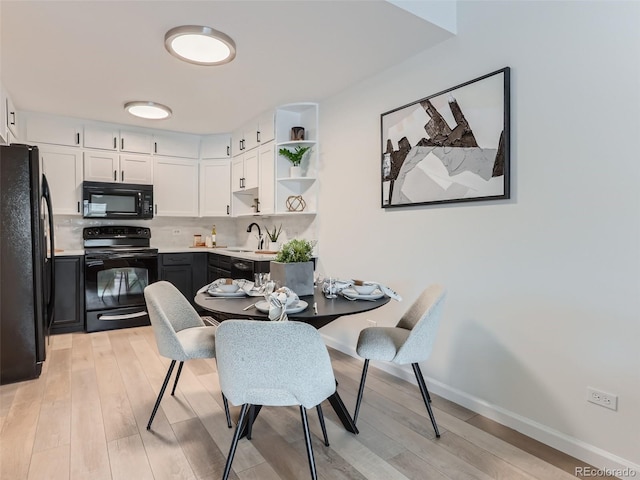 dining room with light hardwood / wood-style flooring and sink