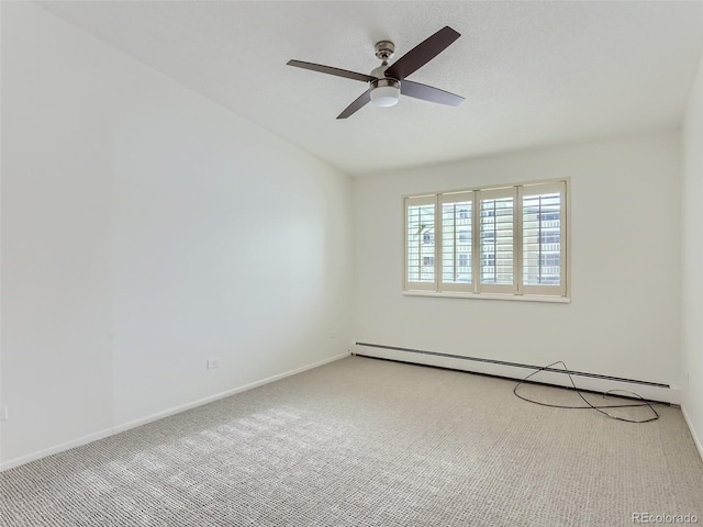 carpeted spare room featuring baseboard heating and ceiling fan