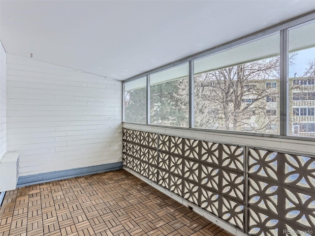 unfurnished sunroom with vaulted ceiling and a healthy amount of sunlight