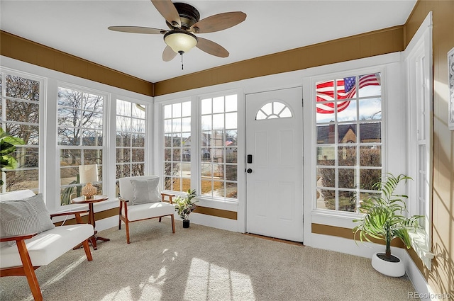 sunroom / solarium featuring ceiling fan