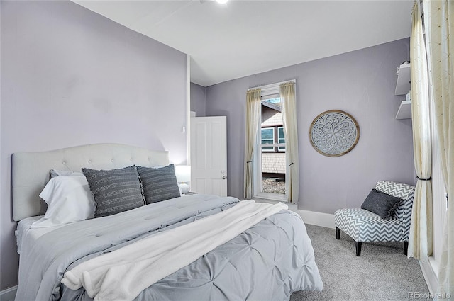 bedroom featuring light carpet and baseboards