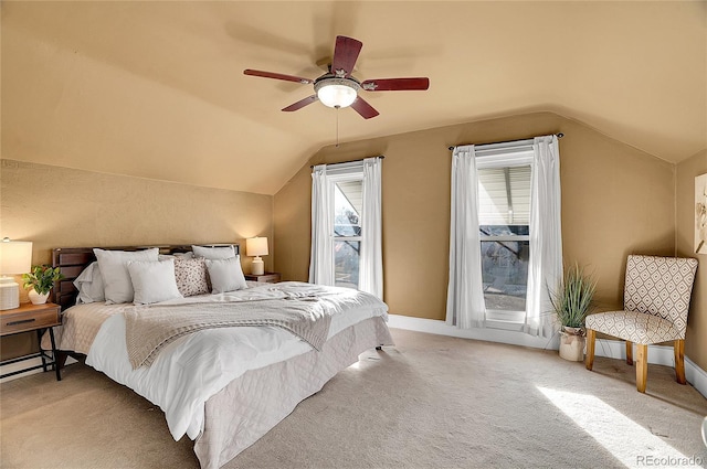 bedroom with lofted ceiling, ceiling fan, baseboards, and light colored carpet