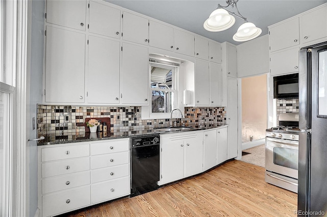 kitchen featuring black appliances, a sink, white cabinetry, and pendant lighting