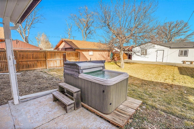 view of yard with a hot tub, fence, and a patio