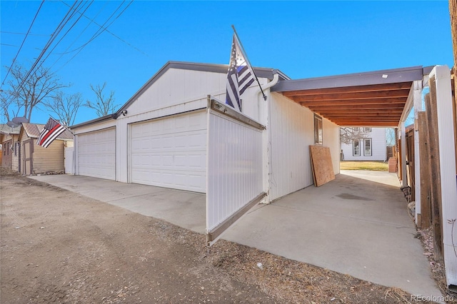 view of home's exterior featuring an outbuilding and a carport