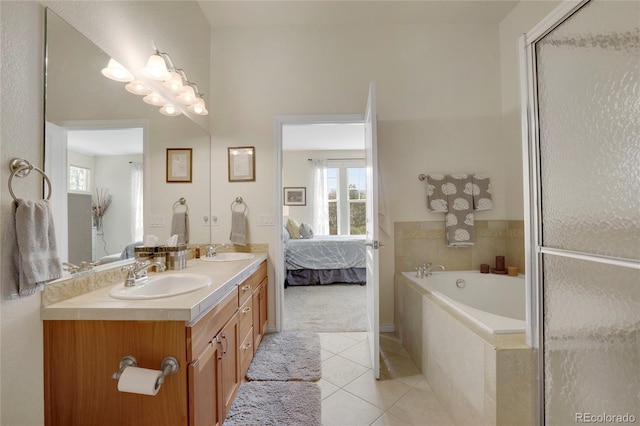 12348 W Gould Ave, Littleton, CO 80127 - ensuite bathroom with tile patterned floors, a bath, double vanity, and healthy amount of natural light