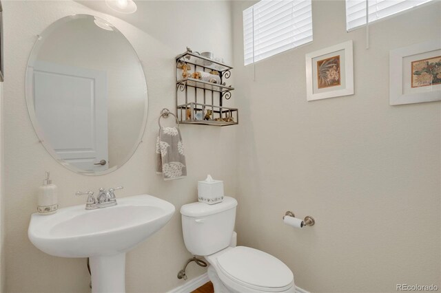 12348 W Gould Ave, Littleton, CO 80127 - bathroom featuring toilet, baseboards, and a sink