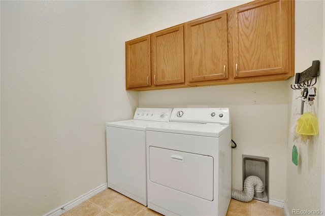 12348 W Gould Ave, Littleton, CO 80127 - clothes washing area featuring cabinet space, washer and clothes dryer, baseboards, and light tile patterned flooring