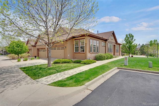 12348 W Gould Ave, Littleton, CO 80127 - view of front of property featuring stucco siding, a front yard, and a garage